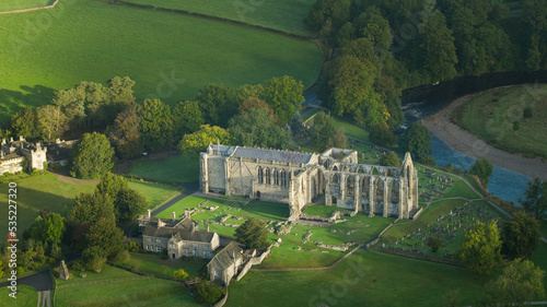 Early morning sunshine illuminates Bolton Abbey in Wharfedale, North Yorkshire, England, takes its name from the ruins of the 12th-century Augustinian monastery now known as Bolton Priory