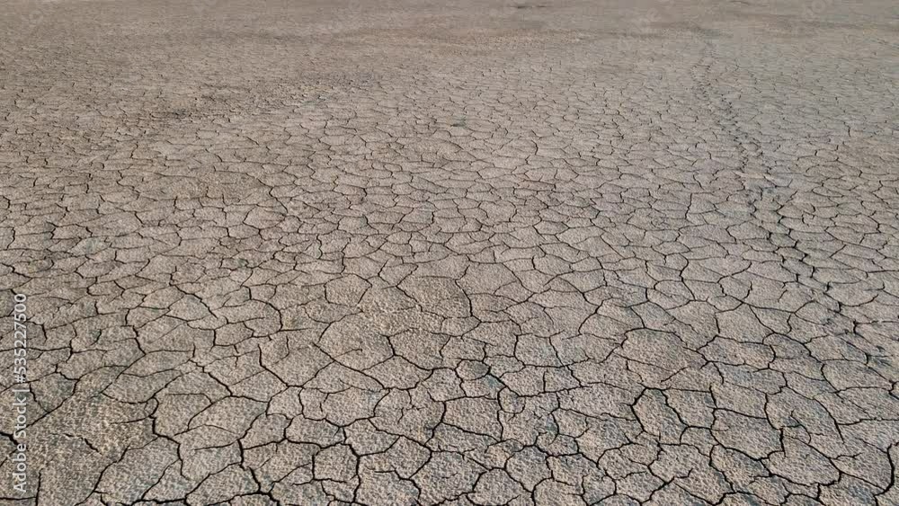 Cracked earth from drought. Global warming, cataclysm. Climate change and dry weather. Economic crisis, food crisis. Poor harvest due to dry weather. Soil erosion. The dried-up mouth of the river.