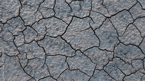 Cracked earth from drought. Global warming, cataclysm. Climate change and dry weather. Economic crisis, food crisis. Poor harvest due to dry weather. Soil erosion. The dried-up mouth of the river.