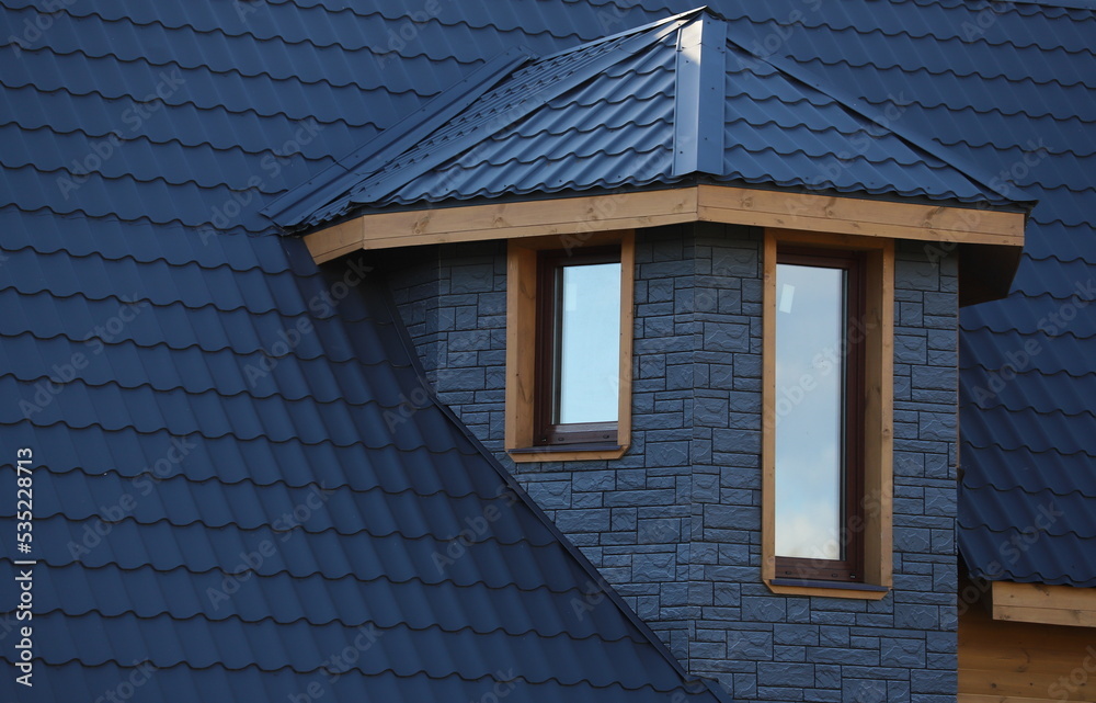 The roof is made of blue metal tiles. Covering the roof of a garden house with metal roof tiles. Built-in windows in the wall of the building. Double-glazed windows installed in the cottage. The roof is made of blue metal tiles. Covering the roof of a garden house with metal roof tiles. Built-in windows in the wall of the building. Double-glazed windows installed in the cottage.