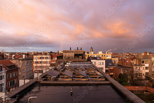 Jette, Brussels, Belgium, Rooftop view over a residential area with a pink reflecting sunset © Werner