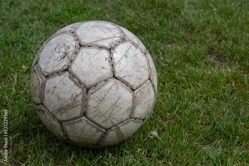 Soccer ball on green grass of football field with copy space
