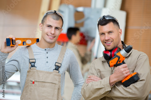 engineer teaching apprentices looking at camera