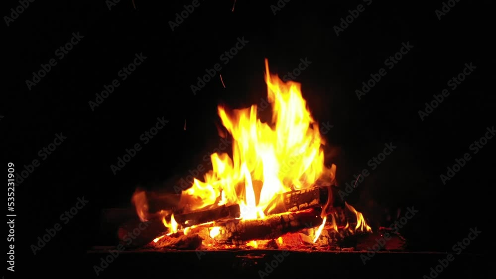 Flames of fire on a black background. Bonfire in the camp. Flames of fire on a black background. Bonfire in the camp.