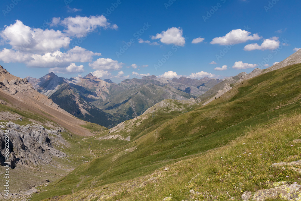 Picturesque view of the Pyrenees landscape with green meadows and mountains during the day. Summer trip in the mountains