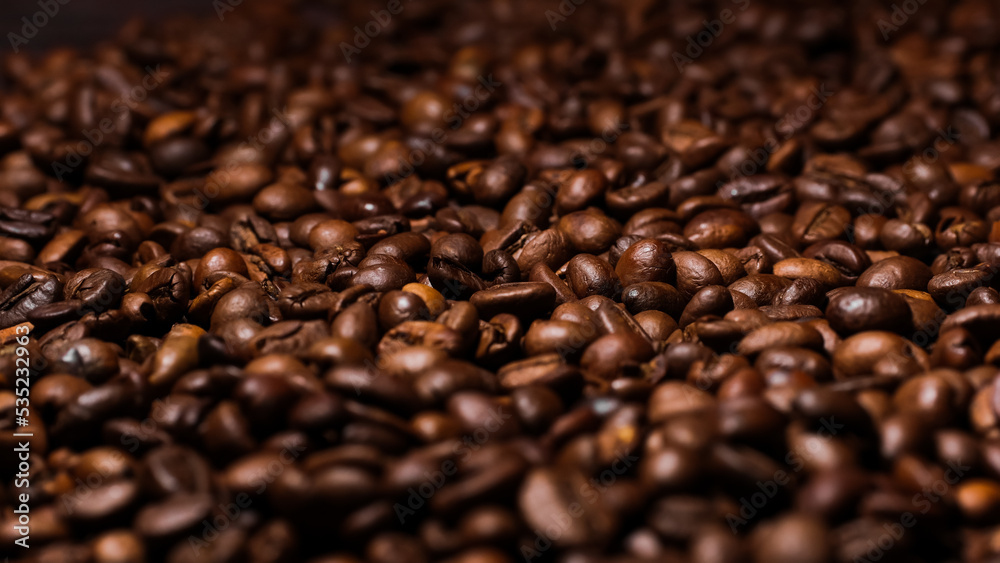 Dark background of roasted coffee beans.