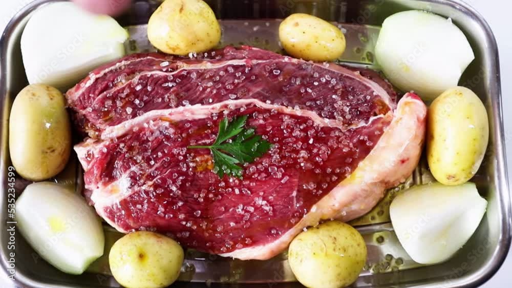 Zoom out seasoning meat with coarse salt and olive oil. Zoom out seasoning meat with coarse salt and olive oil.