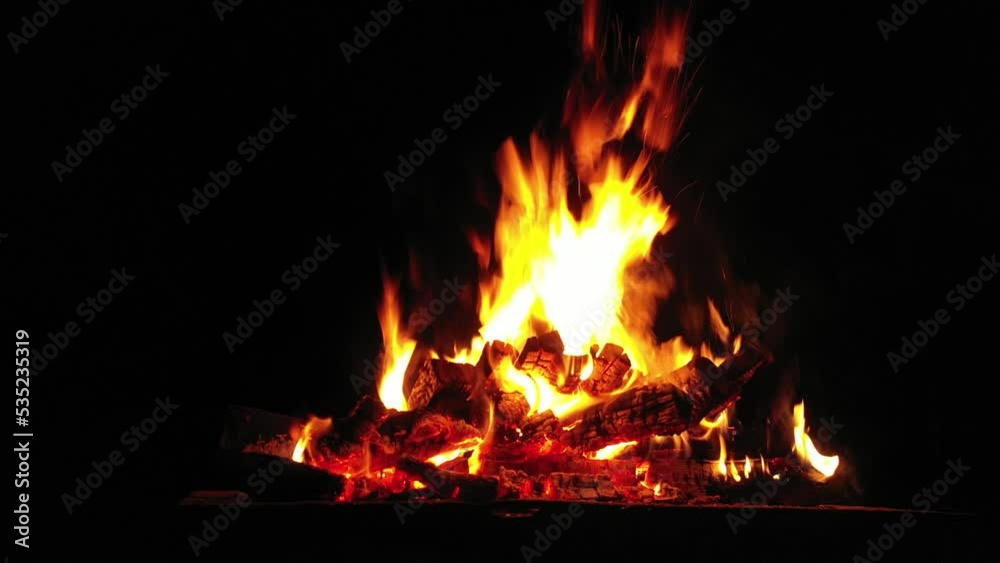 Flames of fire on a black background. Bonfire in the camp. Flames of fire on a black background. Bonfire in the camp.