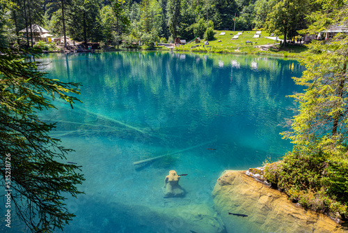 Fotografia The stone statue of the maiden in the Blue Lake (Blausee), in Bernese Oberland,