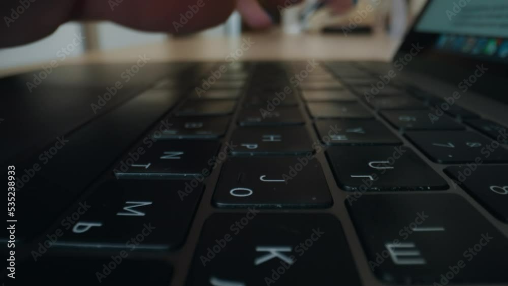Girl's hands typing on a laptop keyboard close-up.