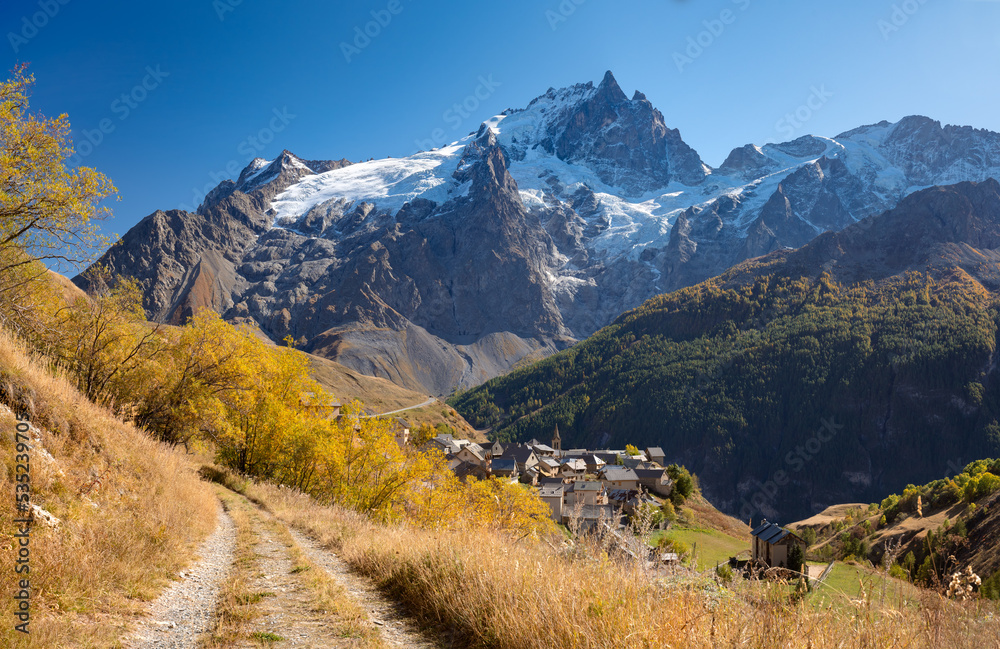 Ecrins National Park Massif with the village of Chazelet facing La Meije peak and glacier in autumn. Hautes-Alpes (French Alps). France