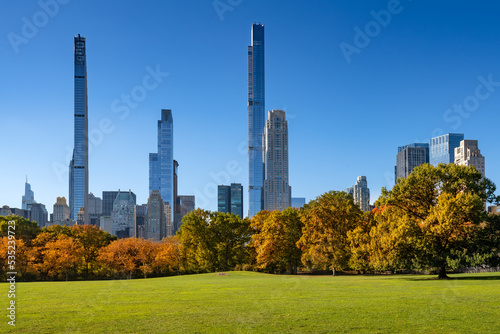Central Park in Fall with Billionaires Row skyscrapers from Sheep Meadow. Midtown Manhattan, New York City