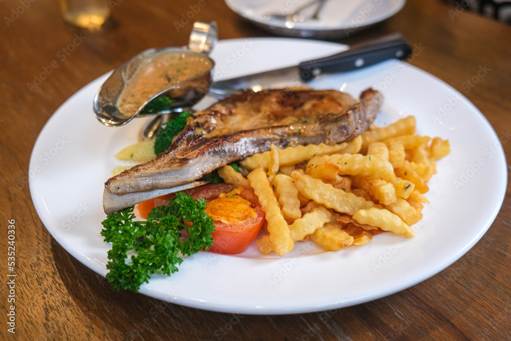 Pork chop steak with french fried on italian restaurant food Pork chop steak with french fried on italian restaurant food