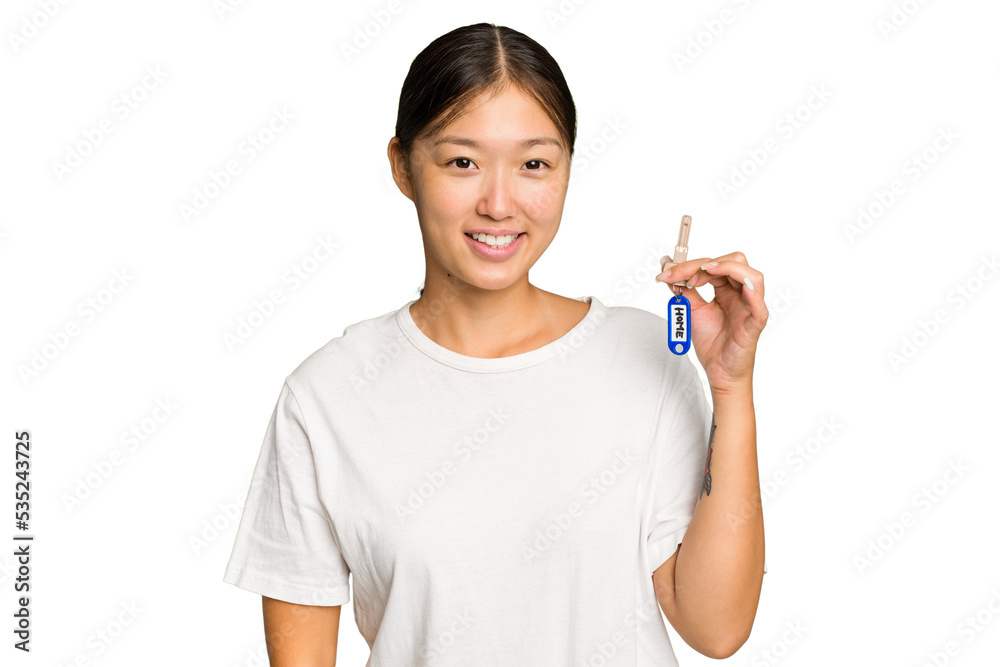 Young asian woman holding home keys isolated on green chroma background happy, smiling and cheerful. Young asian woman holding home keys isolated on green chroma background happy, smiling and cheerful.