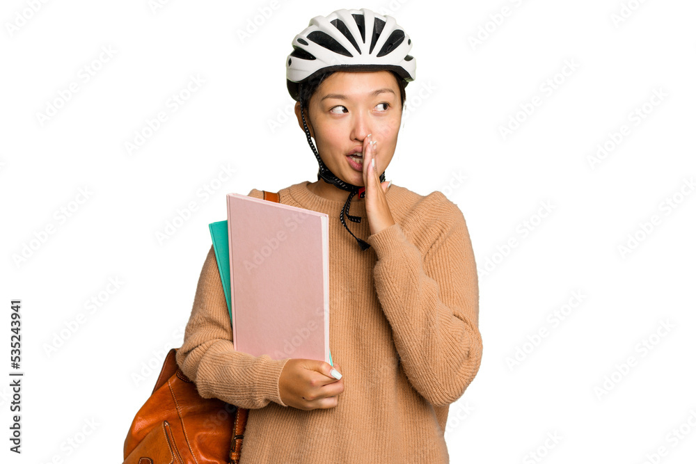 Young student asian woman wearing a bike helmet isolated on green chroma background is saying a secret hot braking news and looking aside Young student asian woman wearing a bike helmet isolated on green chroma background is saying a secret hot braking news and looking aside