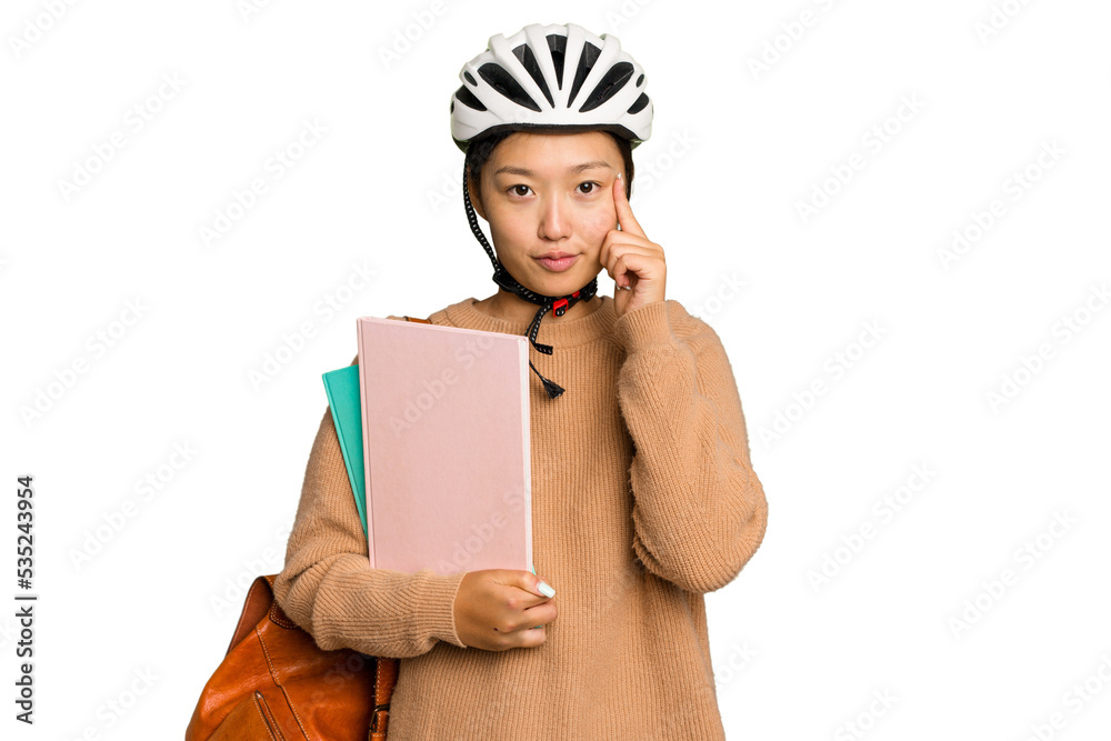 Young student asian woman wearing a bike helmet isolated on green chroma background pointing temple with finger, thinking, focused on a task. Young student asian woman wearing a bike helmet isolated on green chroma background pointing temple with finger, thinking, focused on a task.