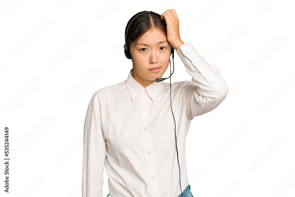 Telemarketer asian woman working with a headset isolated on green chroma background being shocked, she has remembered important meeting. Telemarketer asian woman working with a headset isolated on green chroma background being shocked, she has remembered important meeting.
