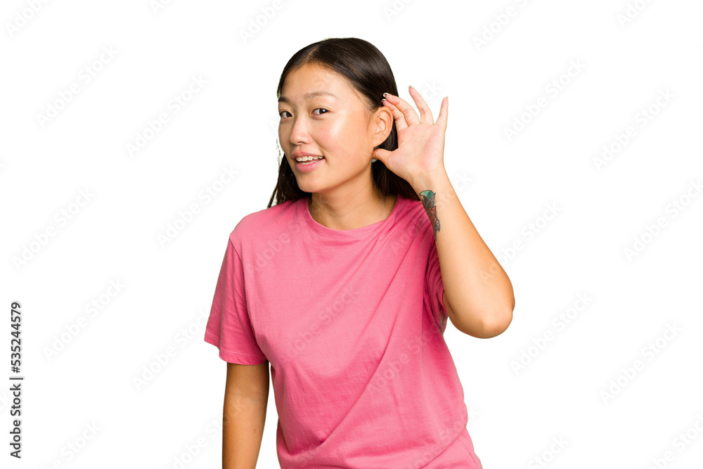 Young Asian woman isolated on green chroma background trying to listening a gossip. Young Asian woman isolated on green chroma background trying to listening a gossip.