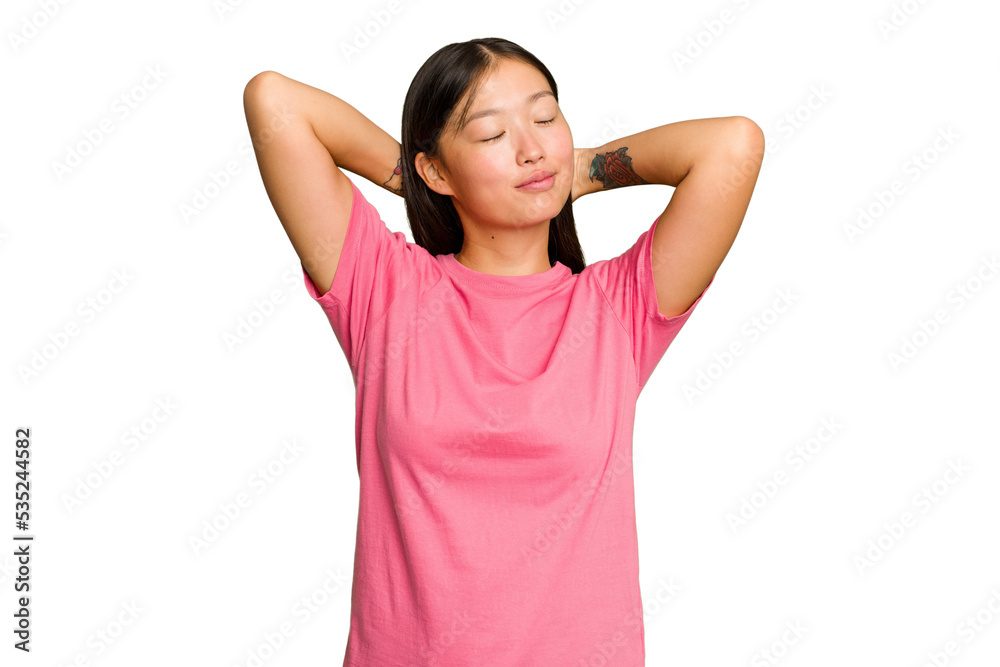 Young Asian woman isolated on green chroma background feeling confident, with hands behind the head.