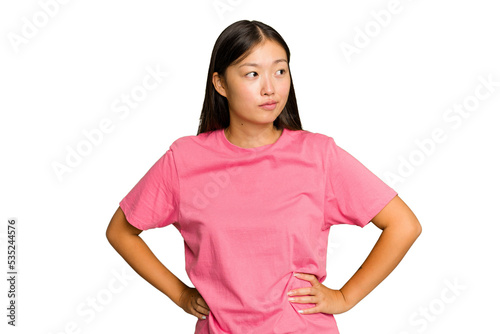 Young Asian woman isolated on green chroma background confused, feels doubtful and unsure.