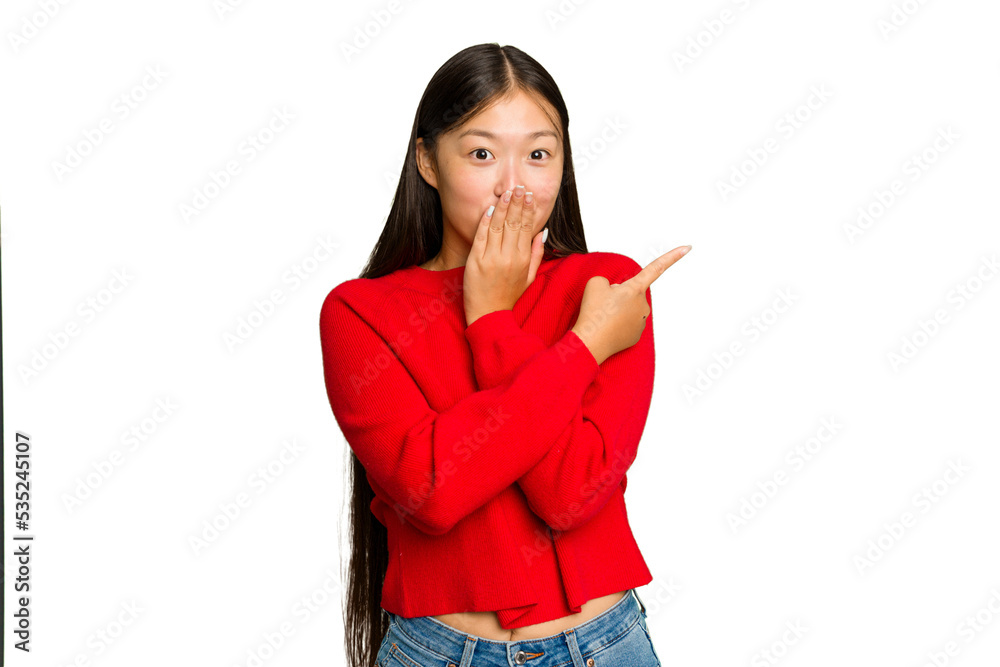 Young Asian woman isolated on green chroma background pointing to the side Young Asian woman isolated on green chroma background pointing to the side