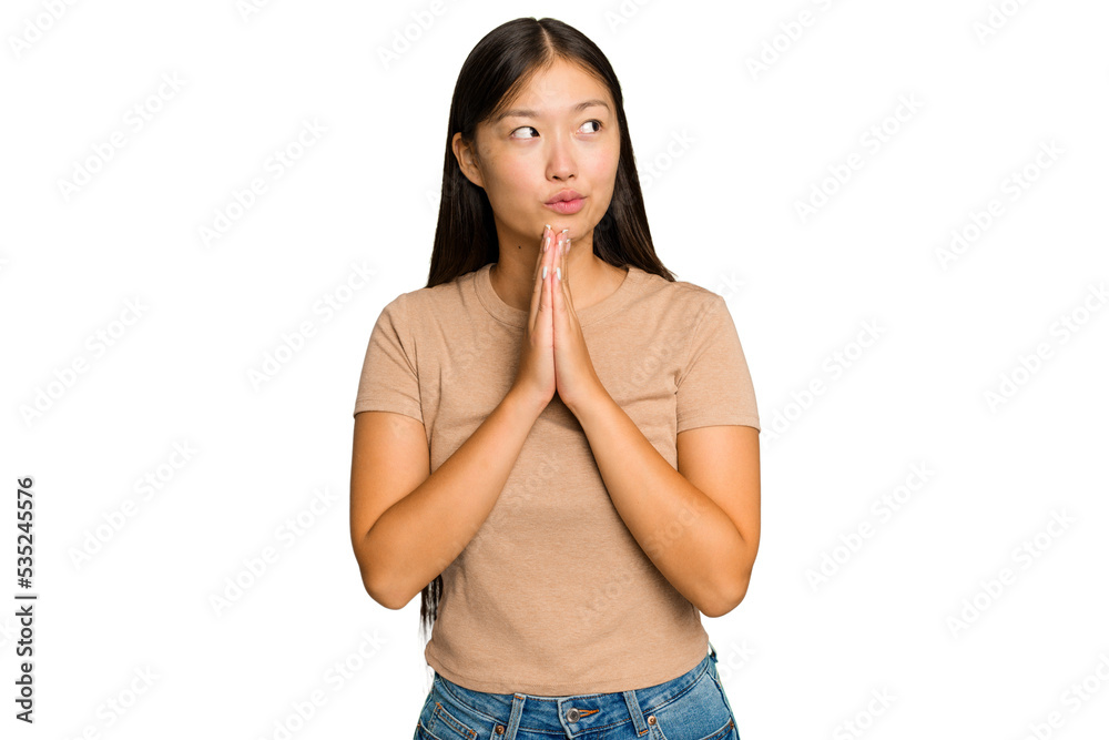 Young Asian woman isolated on green chroma background praying, showing devotion, religious person looking for divine inspiration. Young Asian woman isolated on green chroma background praying, showing devotion, religious person looking for divine inspiration.