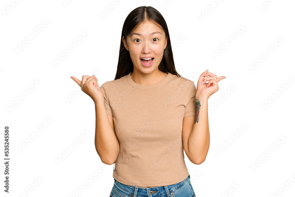 Young Asian woman isolated on green chroma background pointing to different copy spaces, choosing one of them, showing with finger. Young Asian woman isolated on green chroma background pointing to different copy spaces, choosing one of them, showing with finger.