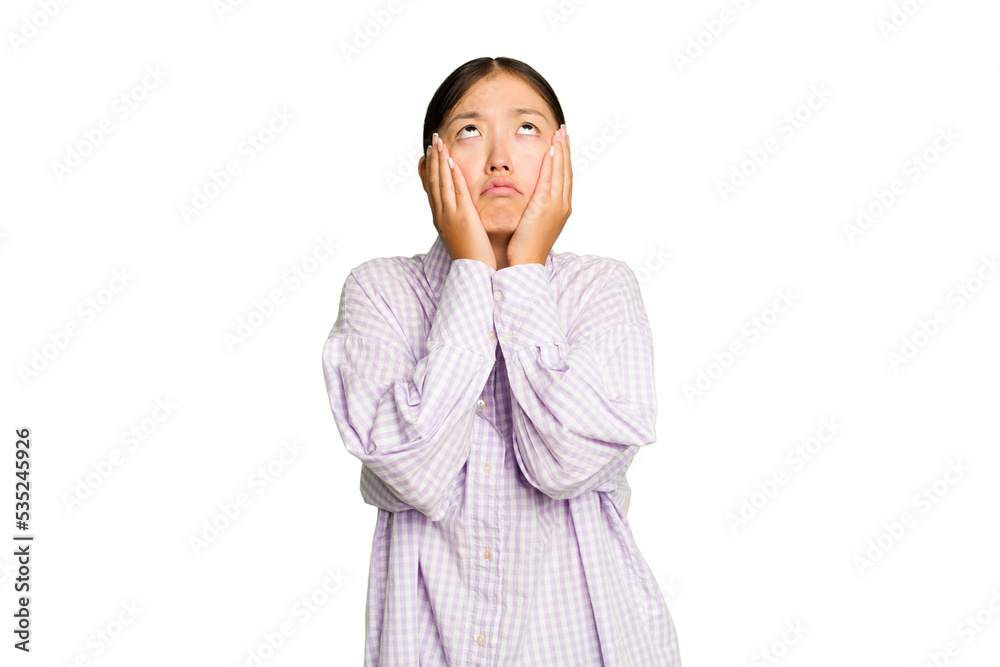 Young Asian woman isolated on green chroma background whining and crying disconsolately.