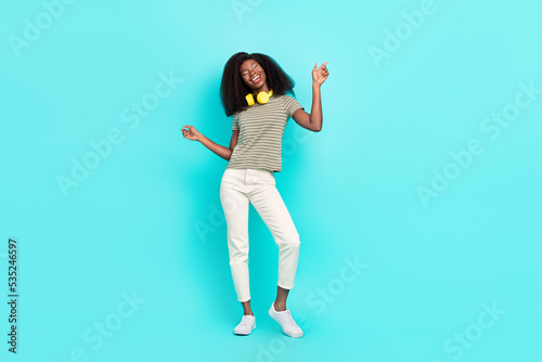 Full size photo of overjoyed positive girl enjoy dancing have good mood isolated on teal color background © deagreez