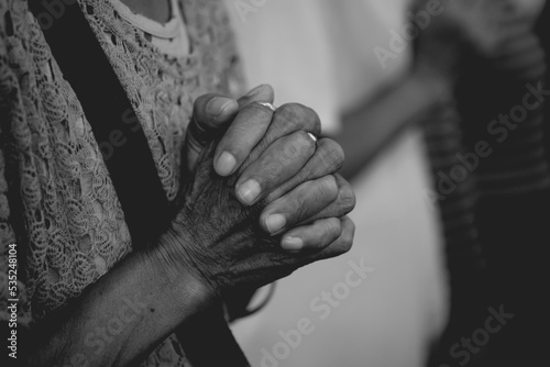 Woman hand praying together at Church.  © NoonVirachada