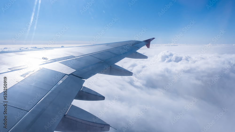 View of the white clouds from the airplane porthole. Travel concept.