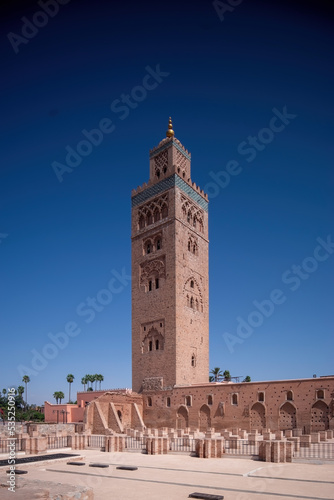 Koutoubia Mosque Minaret in Morocco Marrakesh and gardens during sunset with blue sky. Inside Medina.