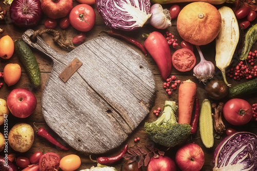 cooking healthy food for weight loss and health. Cutting board on the kitchen table and a variety of fruits and vegetables, autumn harvest