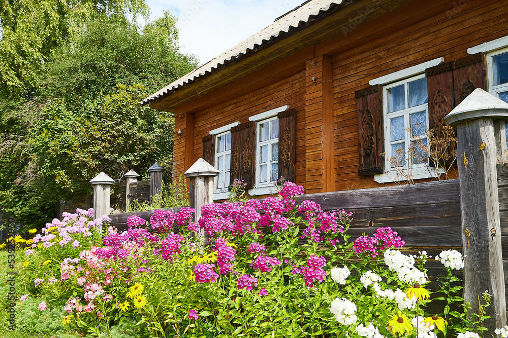 An old village wooden house in summer day in Russia