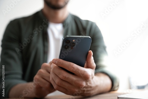 Close up of male hands with mobile. Man pointing on smartphone screen, chatting in social networks