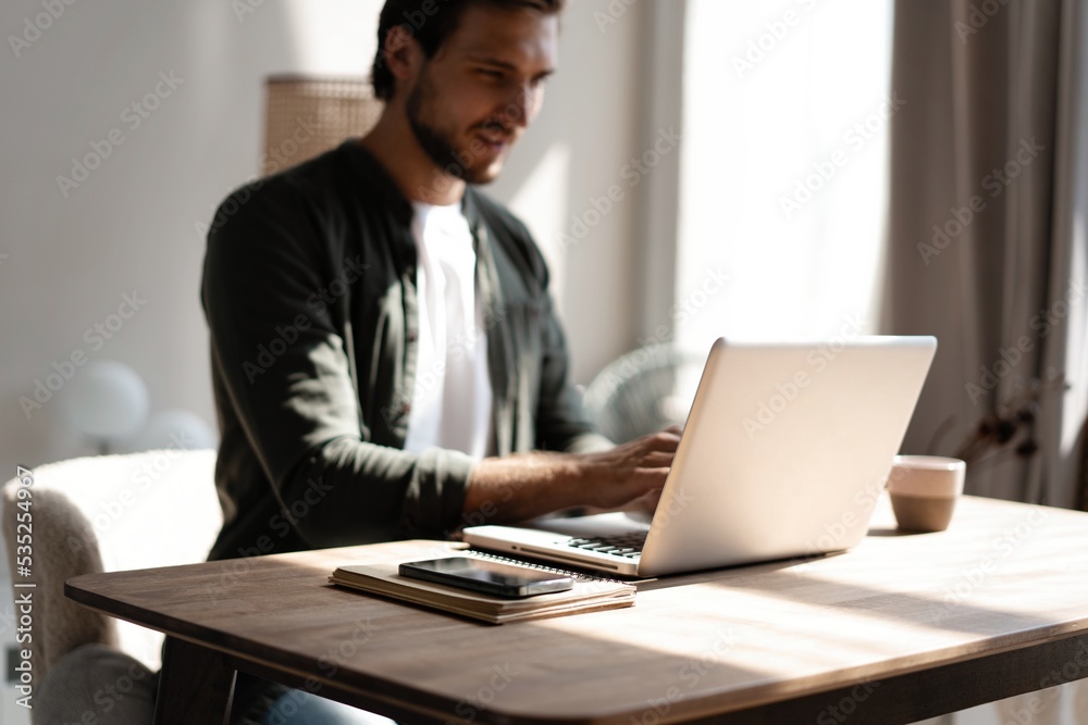Male remote working from home and having work confrence video call. Freelancer working on laptop at home office. Male remote working from home and having work confrence video call. Freelancer working on laptop at home office.