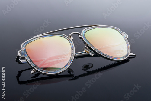 trendy chameleon sunglasses on a black background. style and vision protection fashion accessory