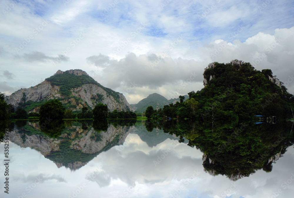 The lake reflects the beautiful mountains during the rainy season.