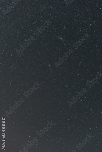 Many stars on black sky at night. A real dark night sky with plenty of stars. Night sky background with selective focus