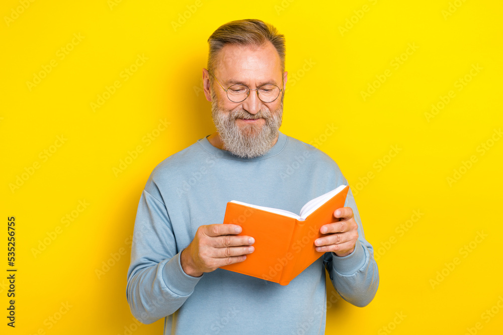 Photo of good mood man pensioner dressed blue pullover eyewear enjoying interesting story isolated yellow color background Photo of good mood man pensioner dressed blue pullover eyewear enjoying interesting story isolated yellow color background