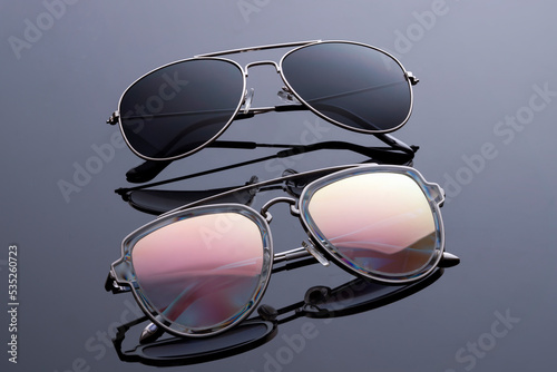 sunglasses black and rainbow chameleon assorted close-up on a black background optics copy space sale