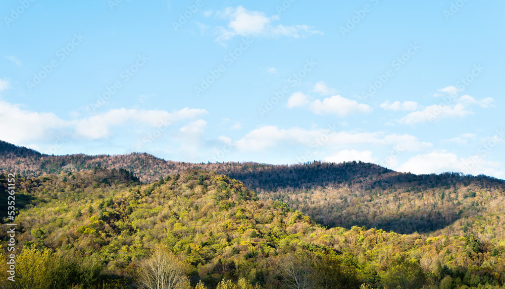 The mountain autumn landscape under blue sky