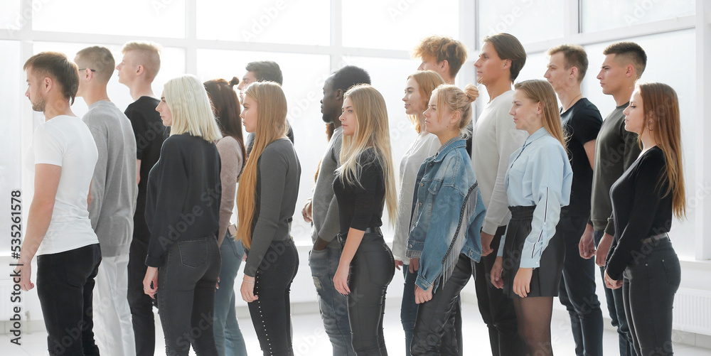 organized group of casual young people standing in a column