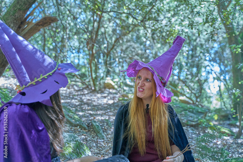 Two young witches in the forest
