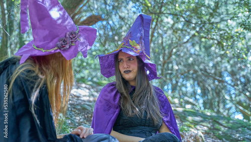 Two young witches in the forest