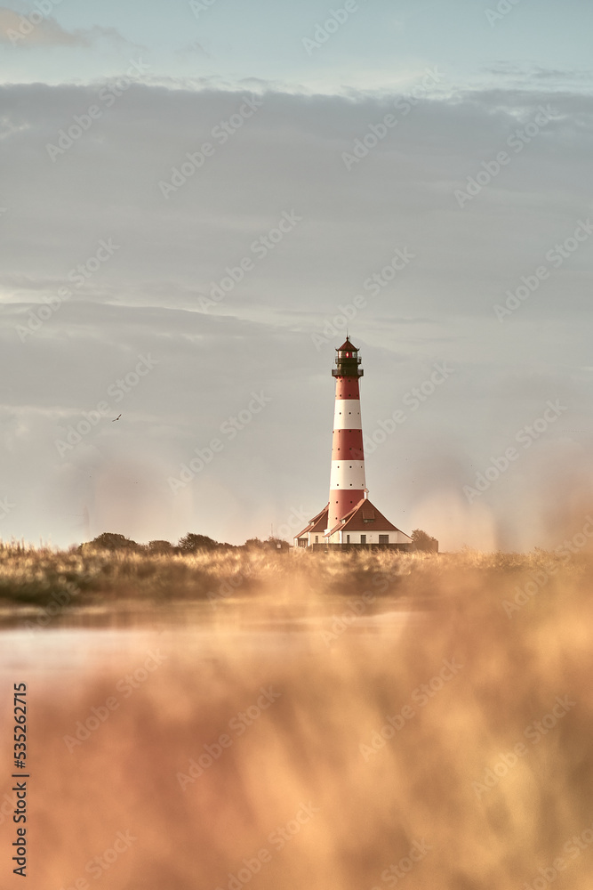 Lighthouse Westerheversand in warm sunrise. High quality photo