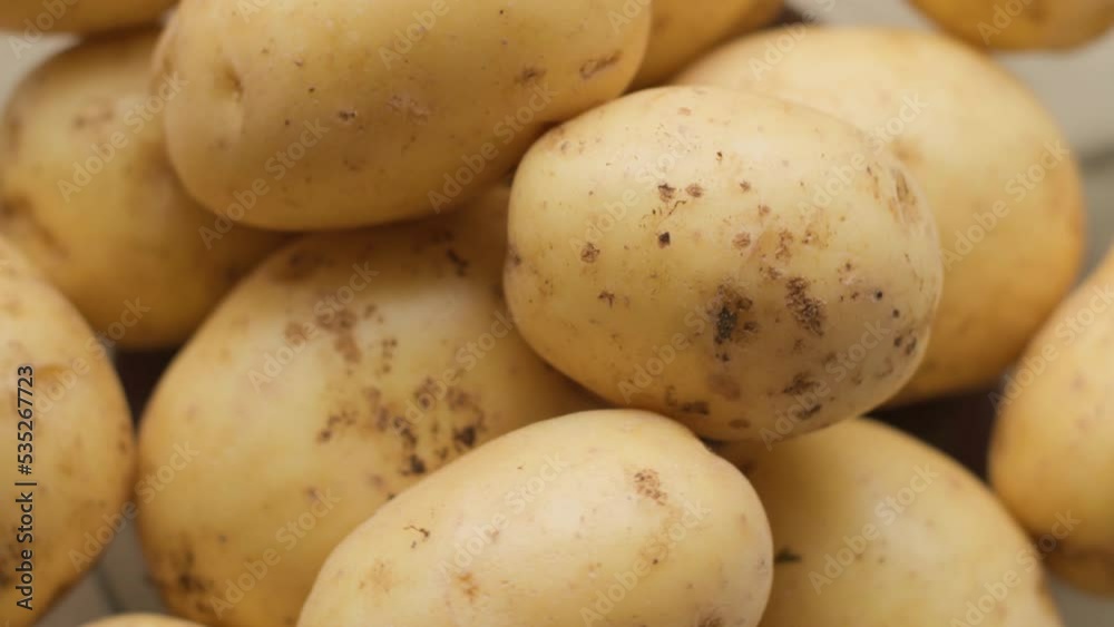 a bunch of young raw potatoes rotate in a circle a bunch of young raw potatoes rotate in a circle