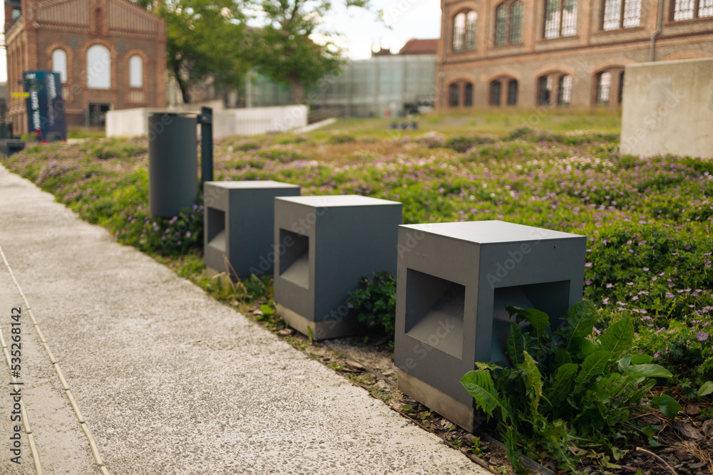 Modern cubic concrete benches in the city square on a sunny day, public places in the city park. High quality photo Modern cubic concrete benches in the city square on a sunny day, public places in the city park. High quality photo