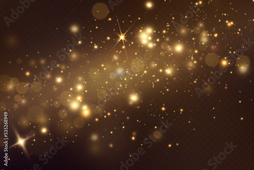 Golden sequins glow with many lights. Glittering dust. Luxurious background of golden particles.