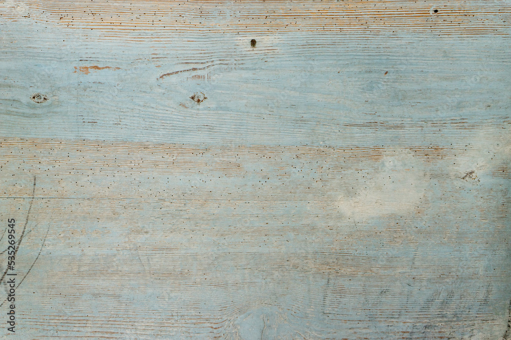 Naklejka premium Blue painted wooden surface is old and weathered.